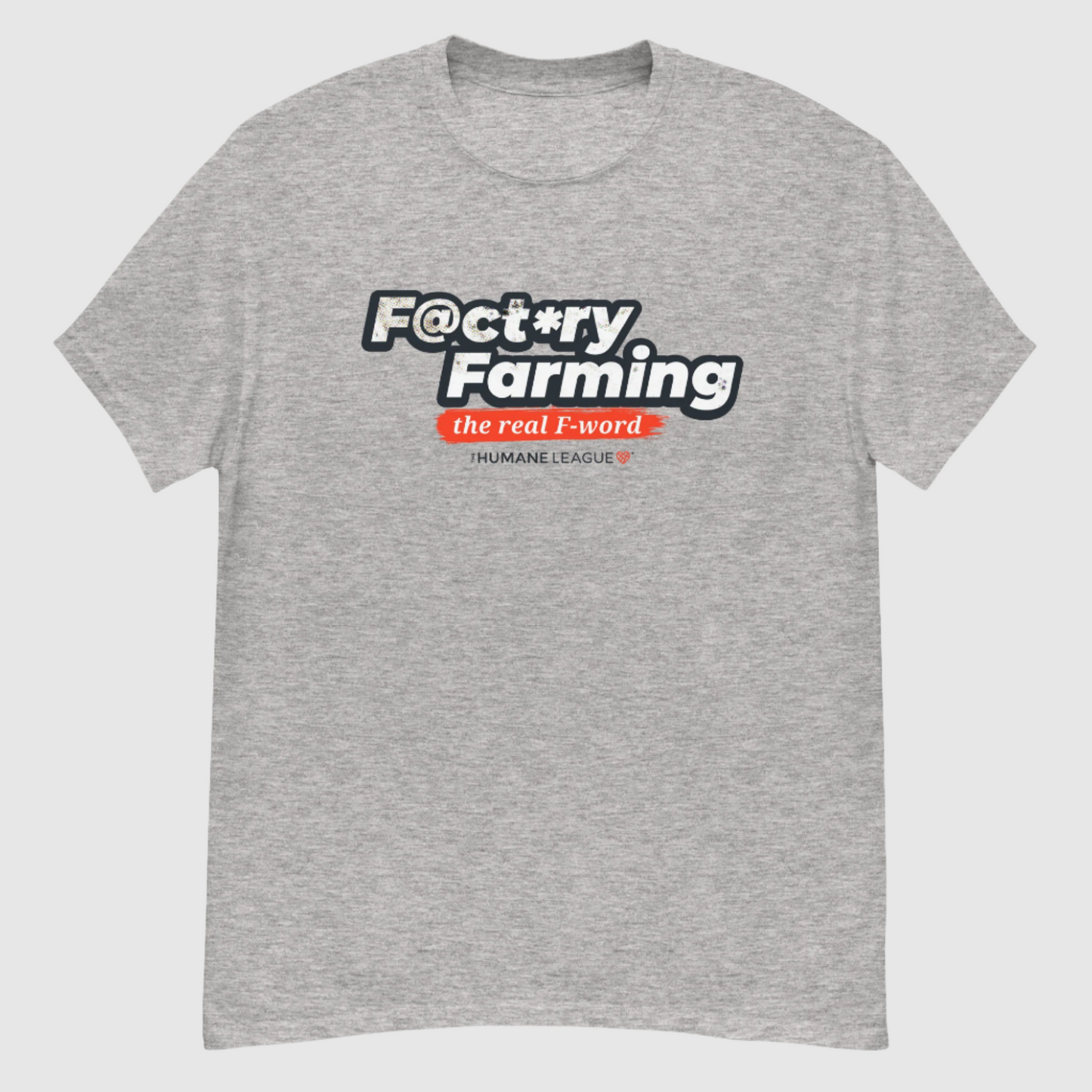 A heather gray short sleeve T-shirt with the words "F@ct*ry Farming" in large, bold letters on the front. Below, in smaller text, it says, "the real F-word" in white inside a bright red brush stroke effect. Underneath, it reads "The Humane League" in smaller font with a small red geometric heart icon next to it.