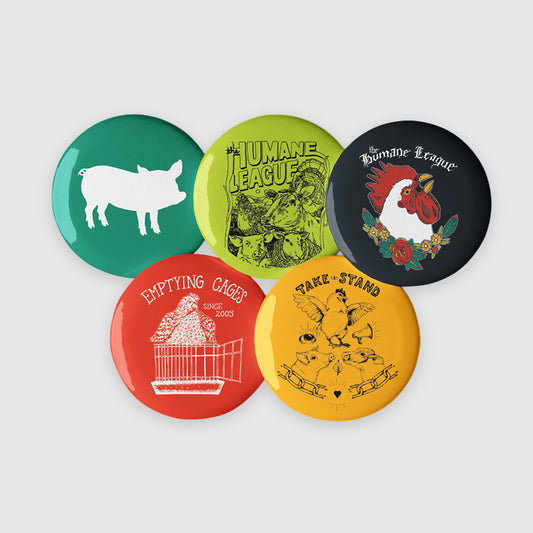 Set of five colorful buttons with various designs on a light gray background