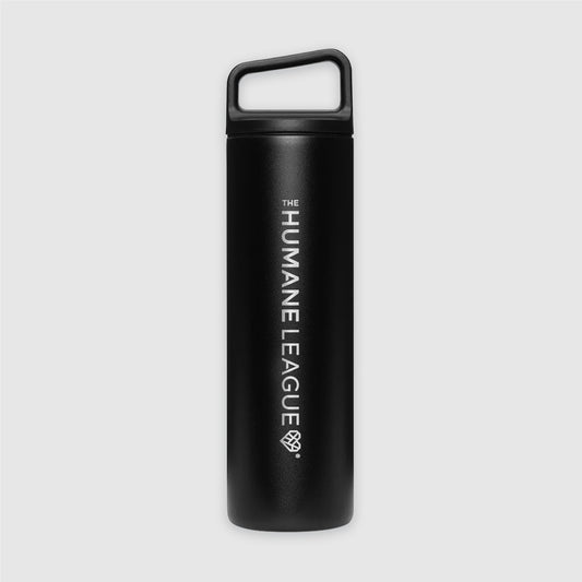 A black metal water bottle with a slanted handle top. The Humane League logo with geometric heart icon is engraved horizontally on the length of the bottle.