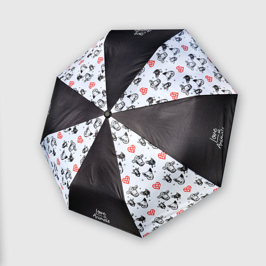 An open umbrella viewed from above, featuring alternating black panels and white panels printed with small black chicken, pig, and cow illustrations and red hearts. The white panels also have the text 'Love All Animals' printed in white.