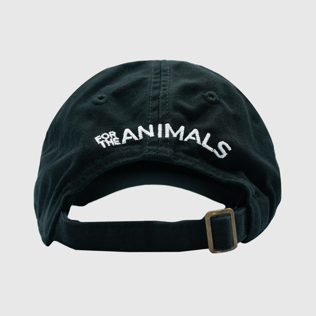 The back of a black baseball cap with "For The Animals embroidered with white thread in a slight arch shape over the back opening in the cap. The cap has an adjustable strap on the back with bronze-colored metal hardware and is photographed against a white background.