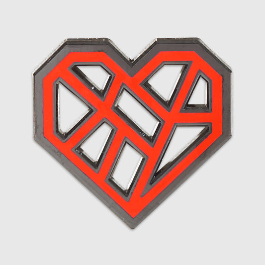 A metal pin in the shape of a geometric heart. The heart design is composed of angular red lines on a dark grey background, creating an abstract, modern look. The heart shape is outlined with a silver metallic border, giving it a three-dimensional appearance.