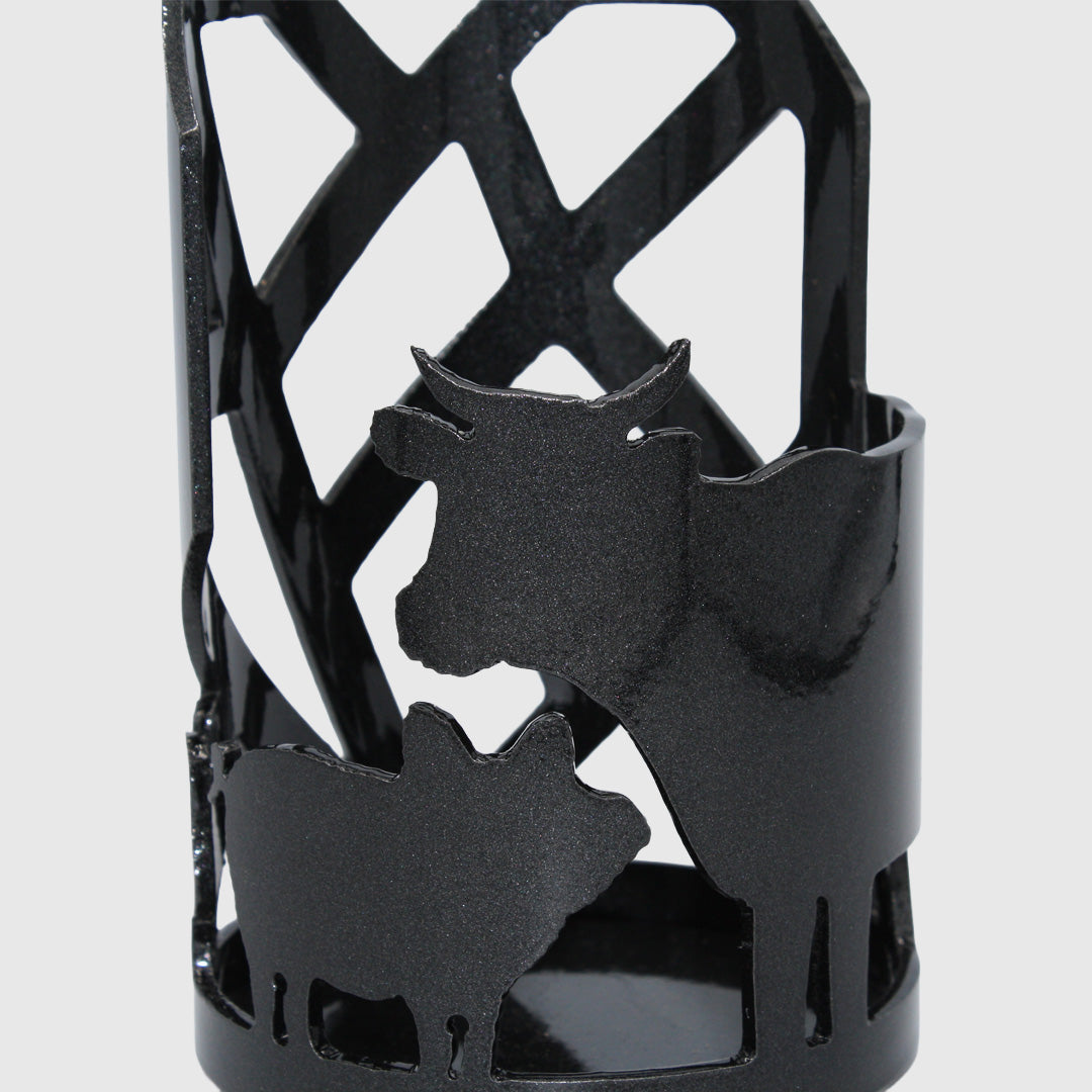 Close up of Black metal candle holder with cow, pig, chicken, and Mended Heart cut outs.