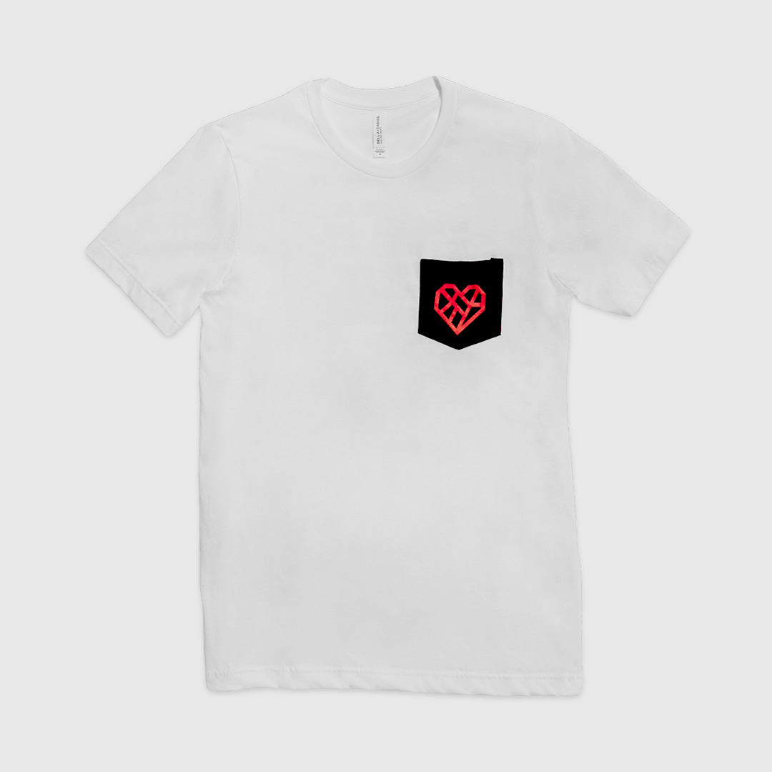 A white short sleeve t-shirt with a black pocket on the wearer's left chest. A vibrant red geometric heart design is printed on the black pocket. The shirt is laid flat against a light background.