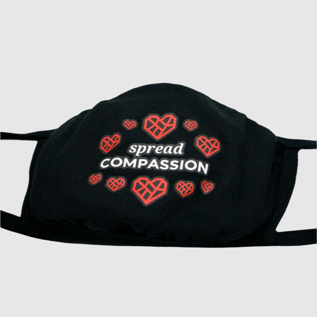 Closeup of the face mask that says "spread COMPASSION".