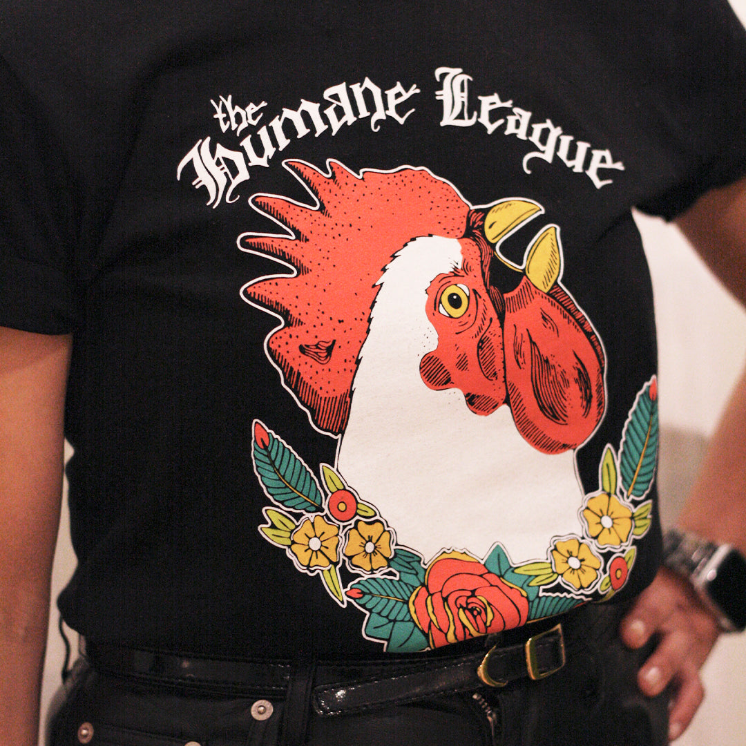 Close up of a person wearing the chicken t-shirt with a black belt and black pants.