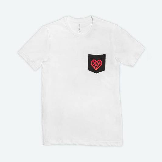 A white short sleeve t-shirt with a black pocket on the wearer's left chest. A vibrant red geometric heart design is printed on the black pocket. The shirt is laid flat against a light background.