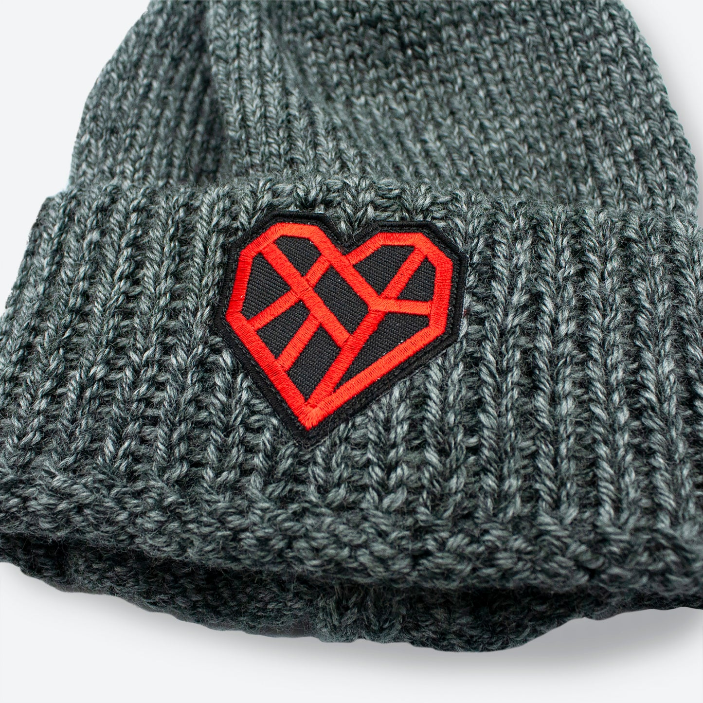 Close up of red and black Mended Heart patch on the front cuff